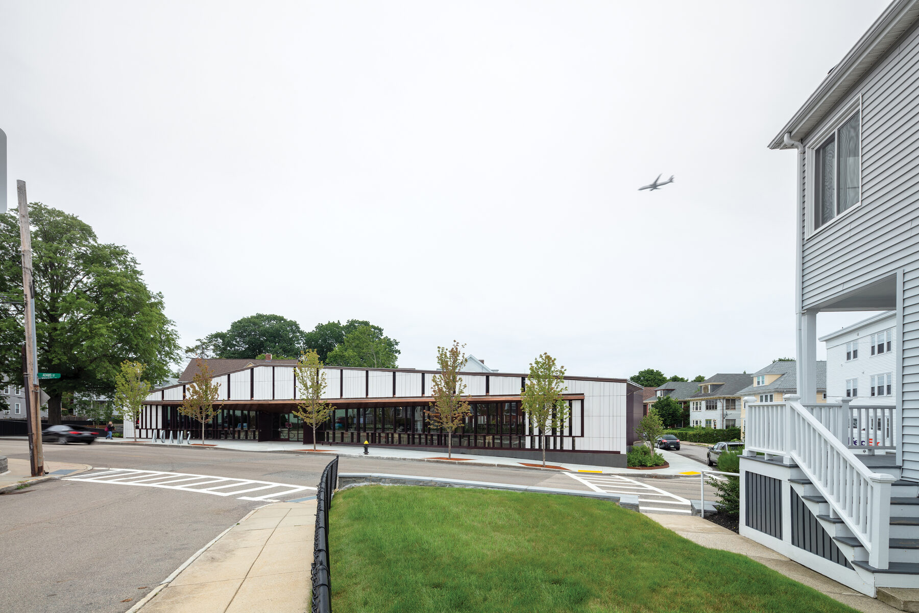 The library viewed from across the street, sitting horizontal in the Dorchester neighborhood fabric