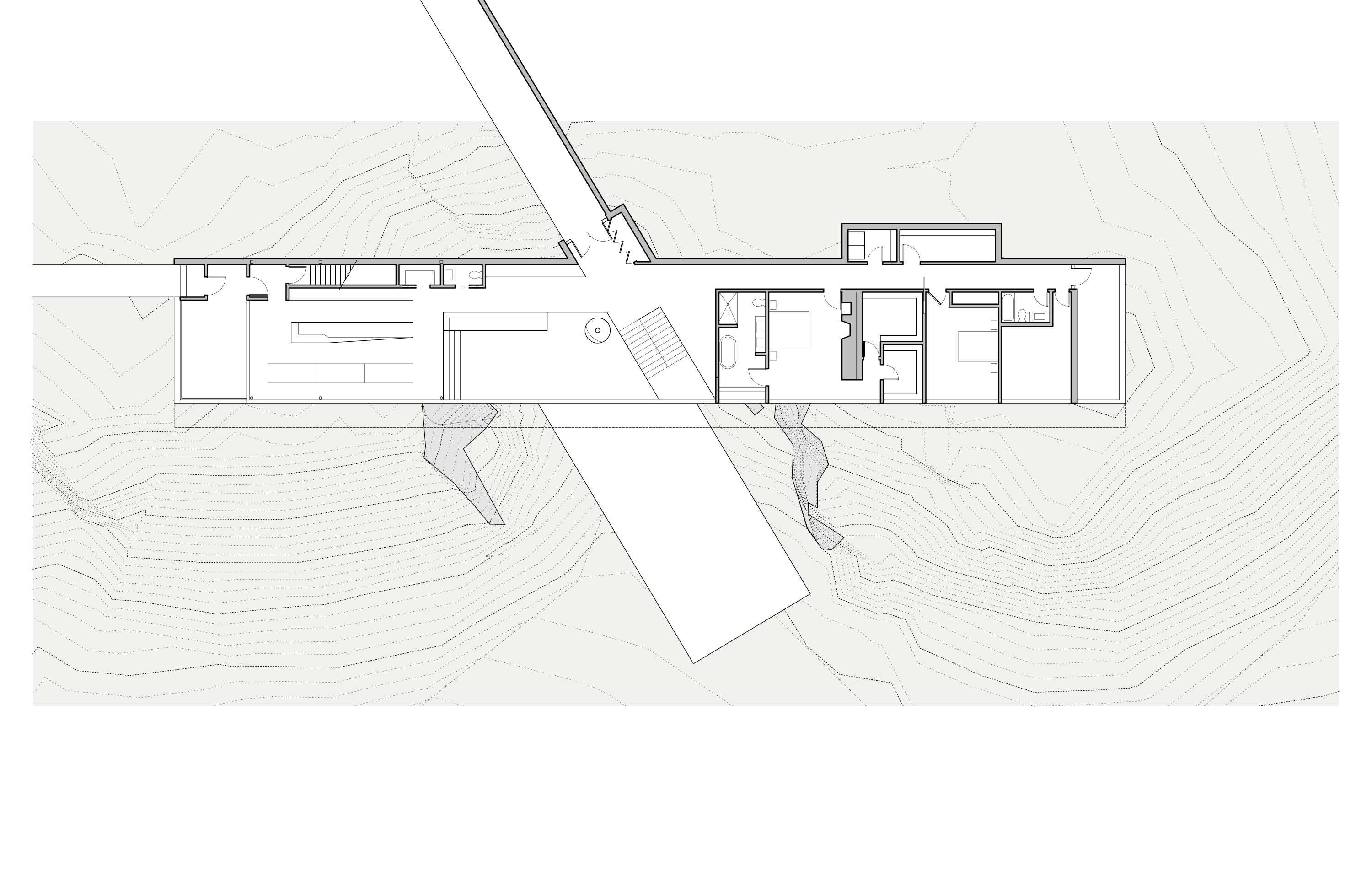 Main level plan: the long horizontal upper floor floating above the contours, the open living and dining wing to the left, the bedroom wing of two bedrooms and a primary suite to the right, and an entry zone with stair down to the lower level through a notch in the middle; the cantilevered floor extends south beyond the supports as a long projecting roof; the driveway approaches from the upper left, the lower volume shown ghosted beneath