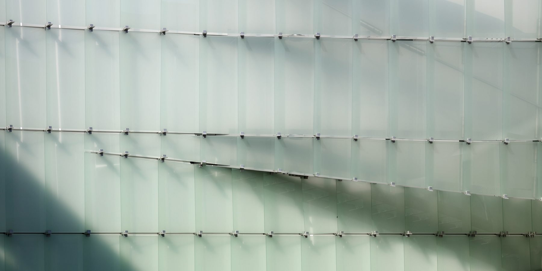 A close view of the glass-shingle skin, the 19 by 50 inch panels lapped in horizontal courses
