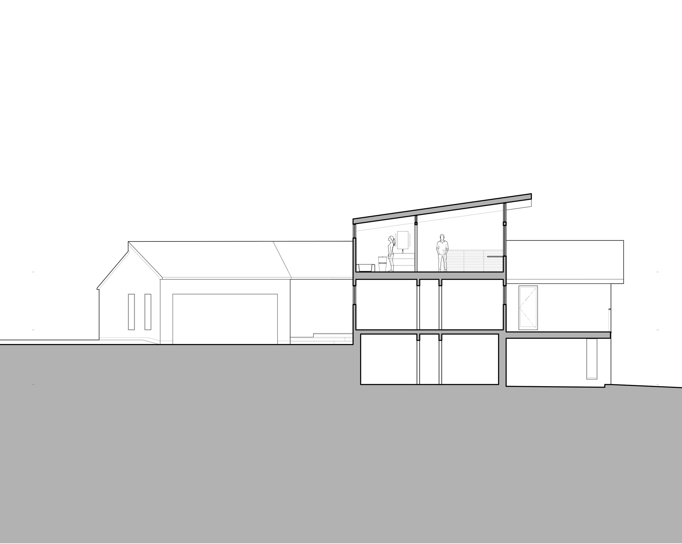 Longitudinal section drawing: the existing one-story gable-roofed house and attached garage shown in elevation at left, the new addition cut through at right showing two stacked levels of new construction over an existing basement level, two figures standing in the upper-level bathroom giving scale, the new sloped roof rising from a lower edge at far right to a higher edge meeting the existing house, the ground line continuous and falling slightly to the right