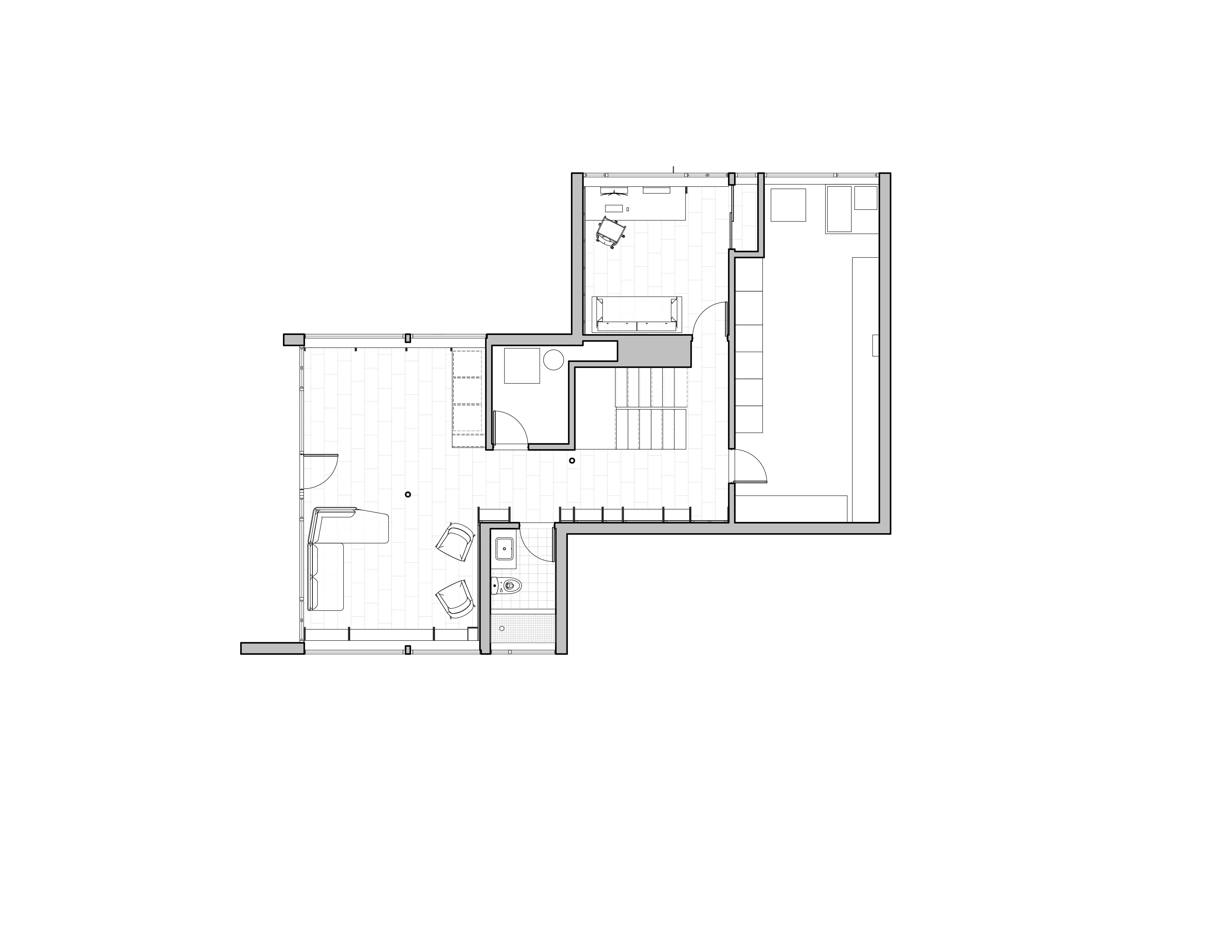 Lower level plan: the family room with sectional and lounge chairs at lower left, the office and guest room at upper, a bath in the middle, the laundry off the corridor, and the stair from the first floor coming down at center
